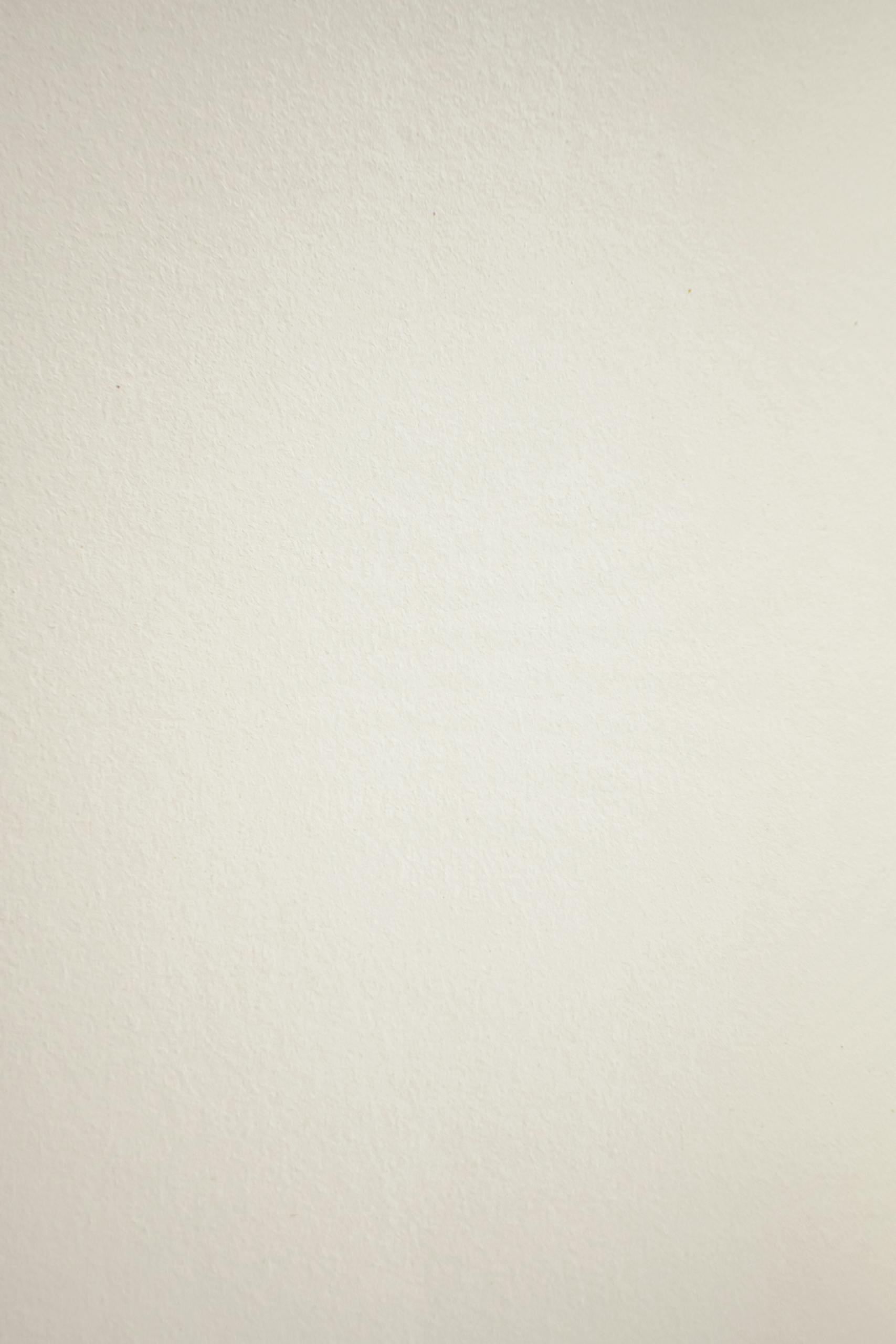A neutral textured paper surface ideal for backgrounds and art projects.