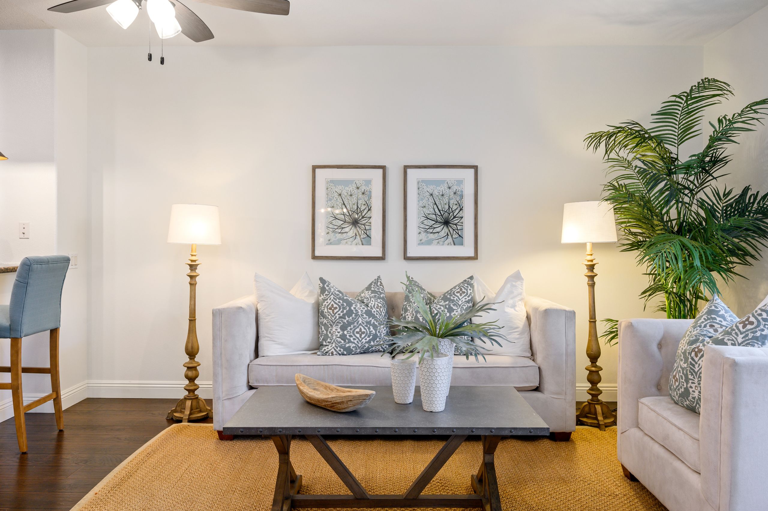 Elegant living room with modern decor, neutral tones, and indoor plants.