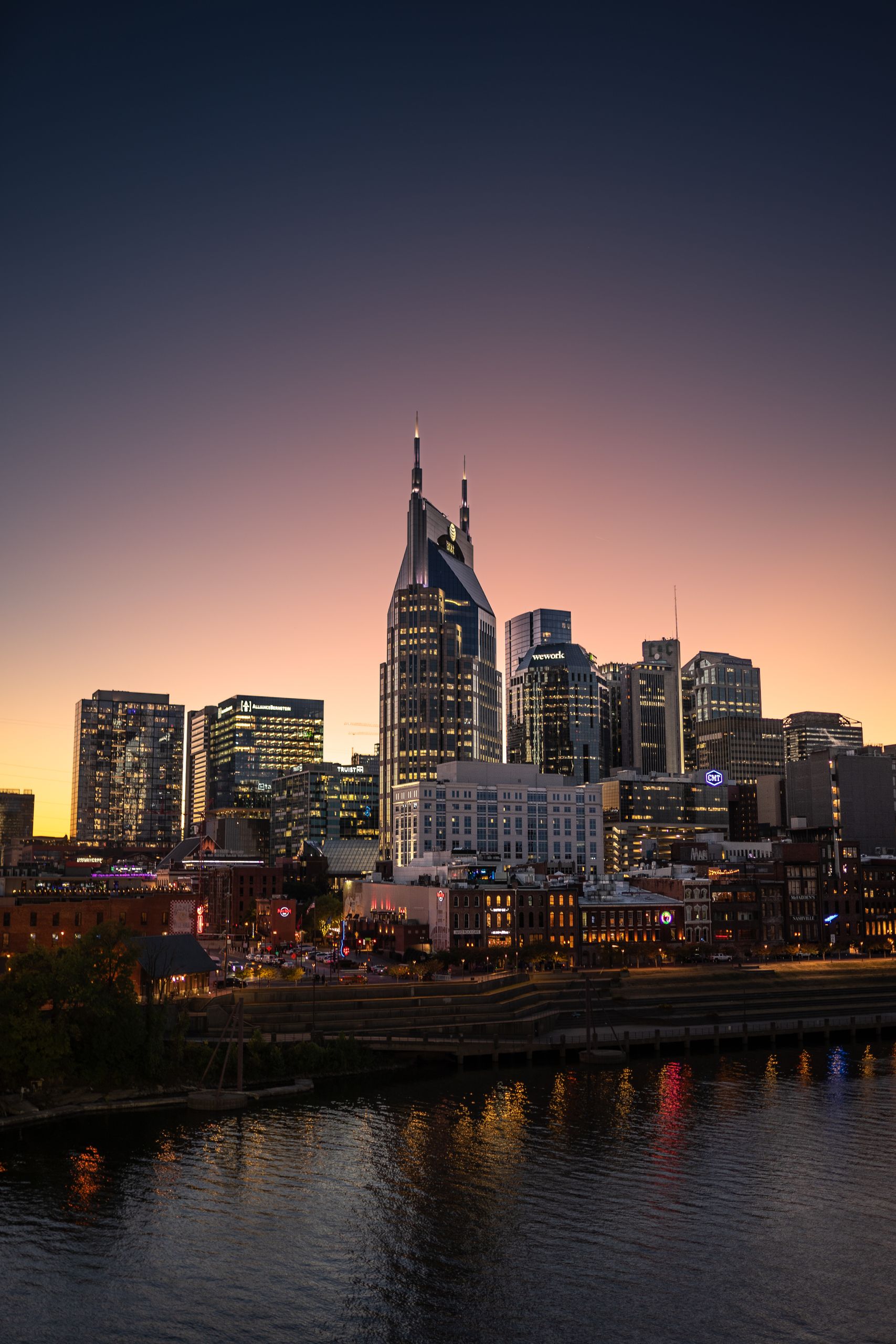Stunning view of Nashville's skyline with AT&T Building at sunset, illuminating modern architecture.